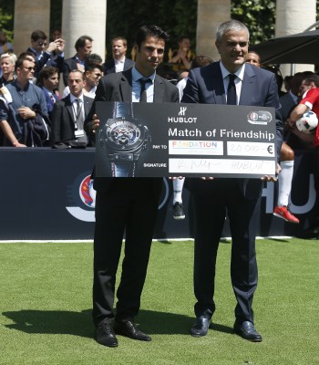 Ricardo Guadalupe, Hublot CEO (L) gives a cheque to Cyril Pellevat, Representative of the Foundation for the Children of the UEFA during the football match of friendship with Pelé and Maradona sponsored by Hublot in Paris, France on 9th of June 2016.