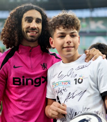 WROCLAW, POLAND - MAY 27: Marc Cucurella of Chelsea poses for a photo with a young fan as part of UEFA Foundation For Children during a Chelsea FC training session ahead of the UEFA Conference League Final 2025 between Real Betis Balompie and Chelsea FC at Stadion Wroclaw on May 27, 2025 in Wroclaw, Poland. (Photo by Boris Streubel - UEFA/UEFA via Getty Images)