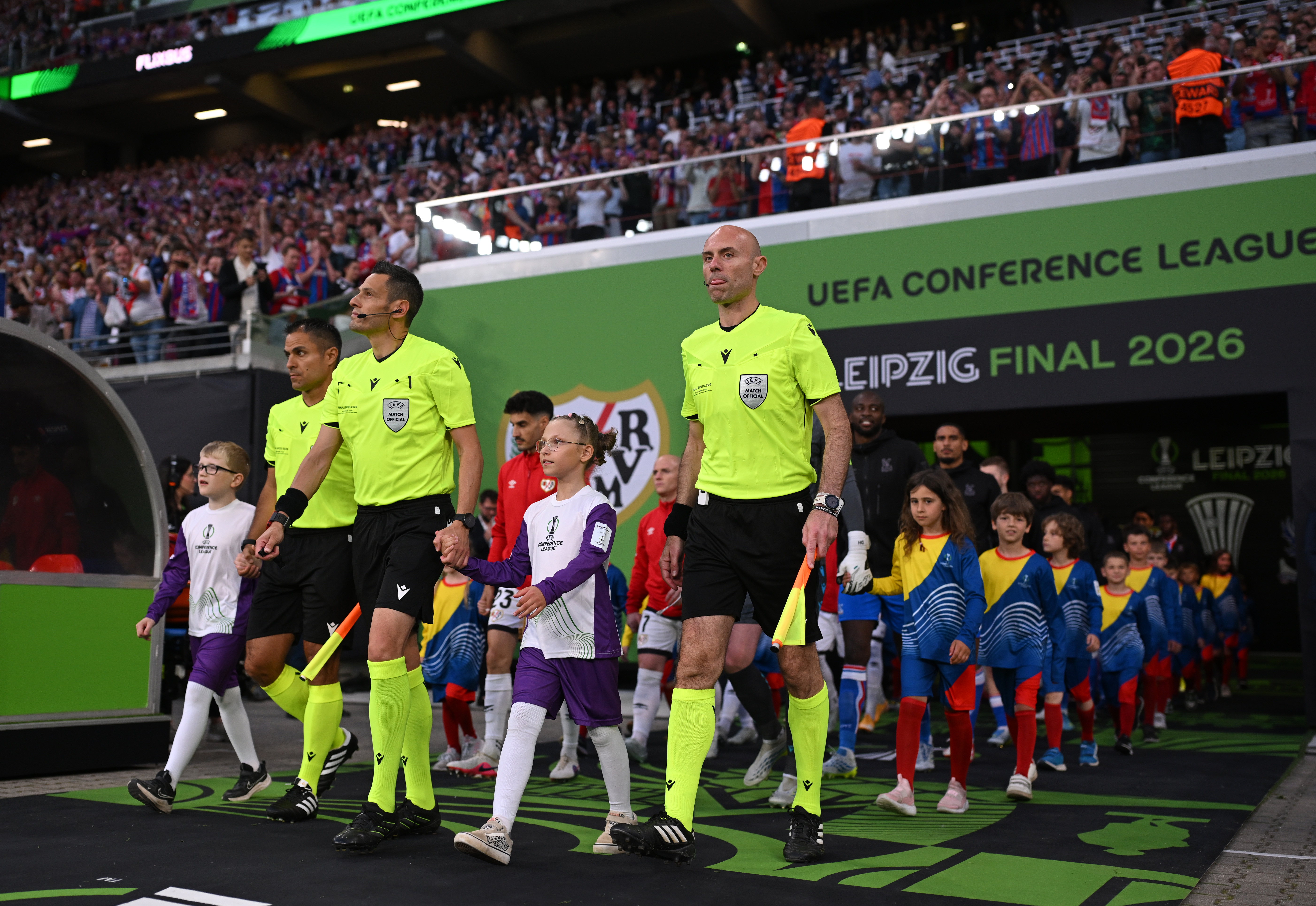 LEIPZIG, GERMANY - MAY 27: Referee, Maurizio Mariani and Assistant Referees, Daniele Bindoni and Alberto Tegoni, lead the teams out prior to the UEFA Conference League Final 2026 match between Crystal Palace FC and Rayo Vallecano de Madrid at Football Arena Leipzig on May 27, 2026 in Leipzig, Germany. (Photo by Thomas Eisenhuth - UEFA/UEFA via Getty Images)
